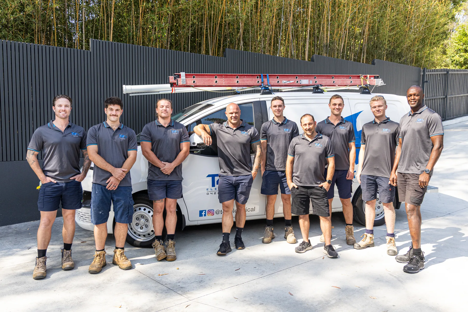 The Family Electrician Upper Coomera team with a service van